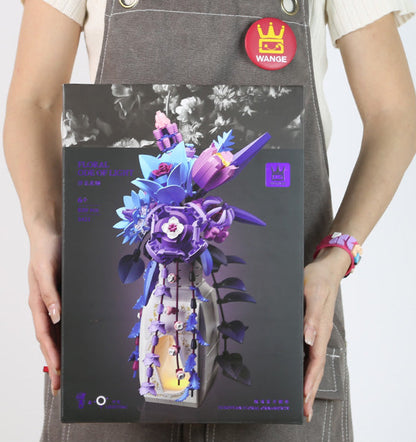 Person holding a product box with a colorful flower design on a white background
