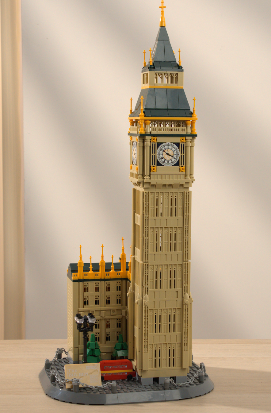 LEGO model of Big Ben on a wooden surface with a neutral background